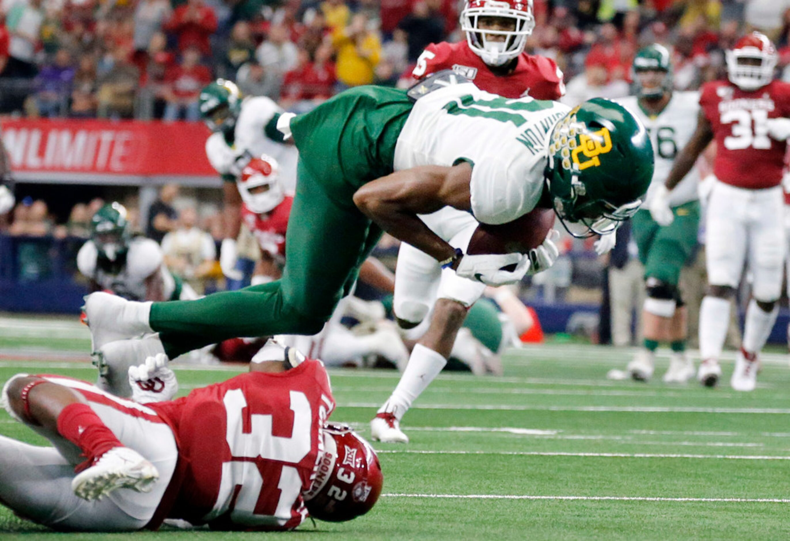 Baylor Bears wide receiver Tyquan Thornton (81) is tripped up after making a second quarter...