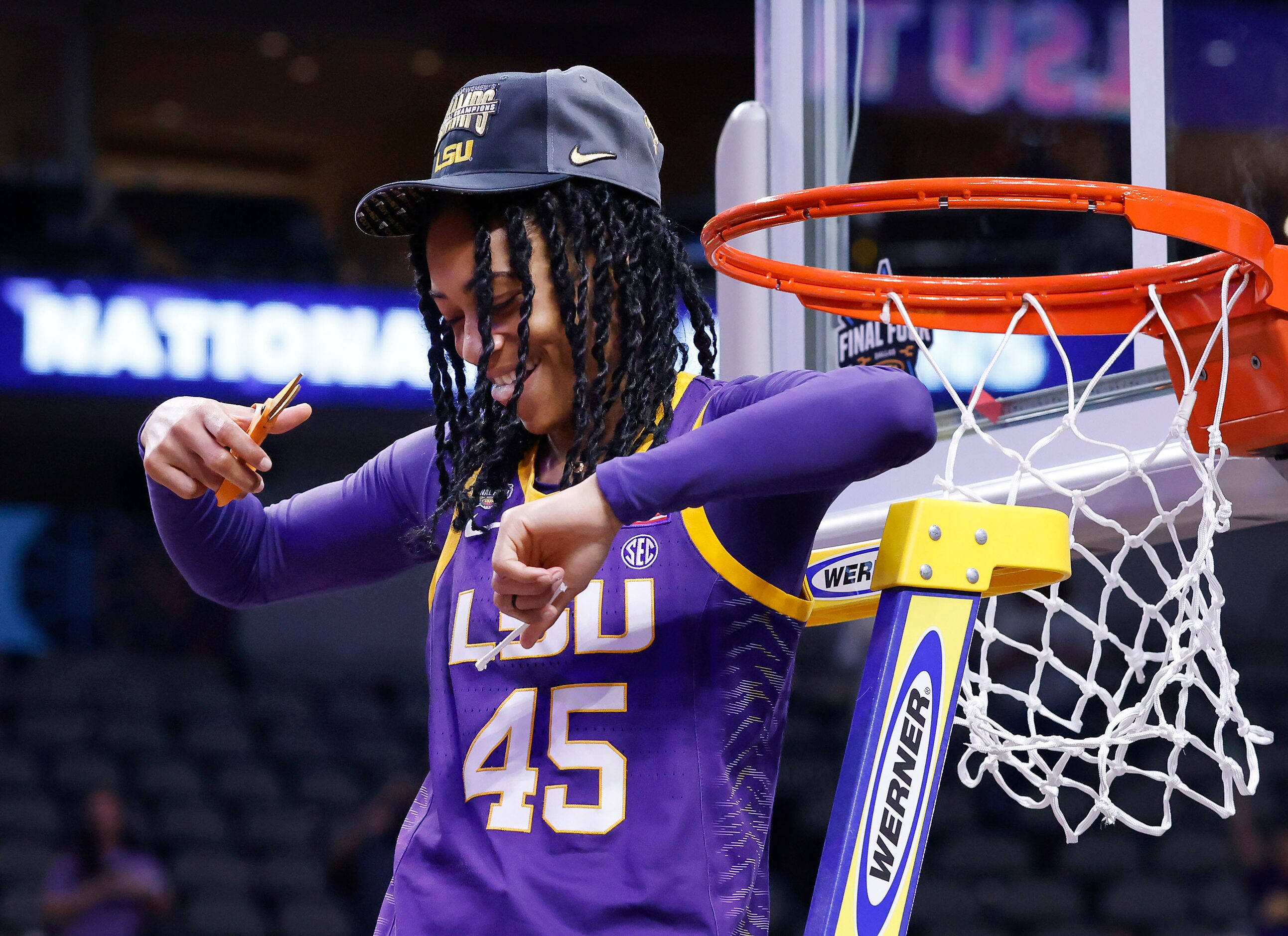 LSU Lady Tigers guard Alexis Morris (45) dances on the ladder after cutting part of the net...