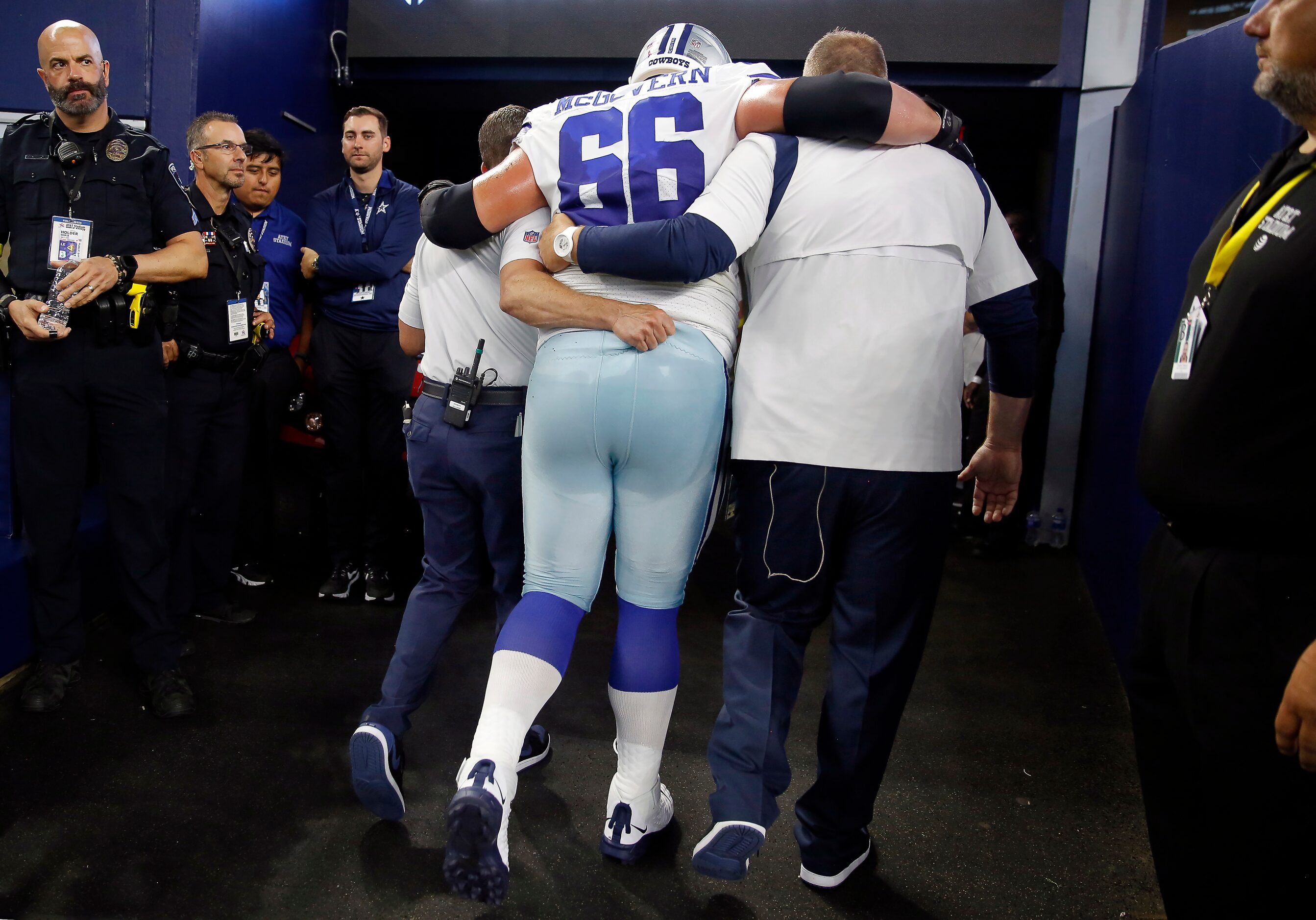 Dallas Cowboys guard Connor McGovern (66) is helped to the locker after sustaining a first...