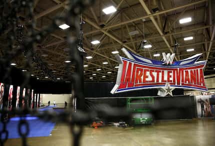 Workers set up for WrestleMania Axxess at the Kay Bailey Hutchison Convention Center in...