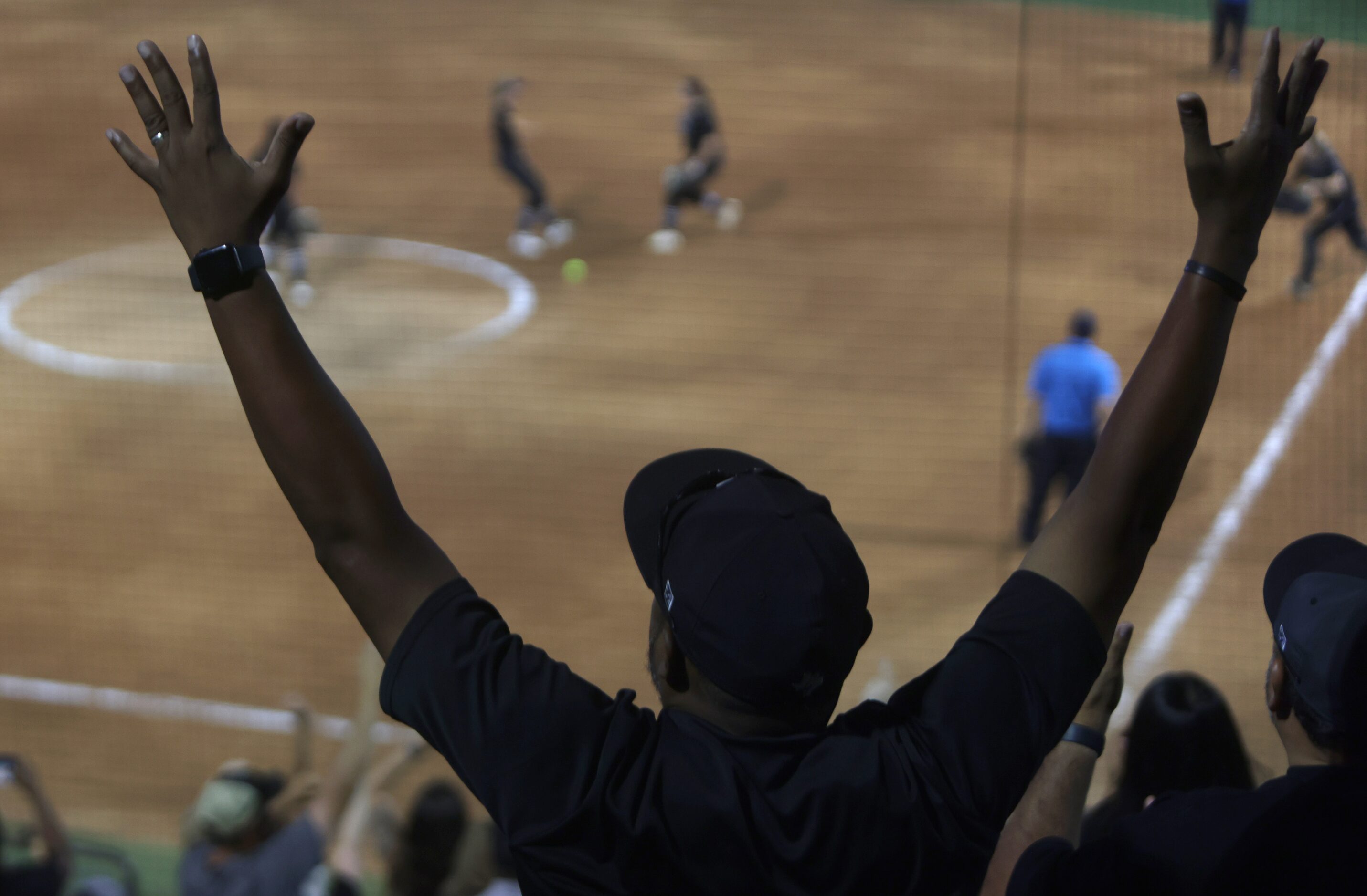 Marcus Williams raises his arms in celebration as Denton Guyer players run onto the field...