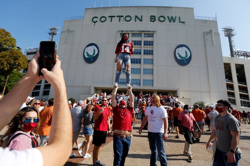 Emily Bingger of Norman has her photo taken in front of the Cotton Bowl before the Red River...