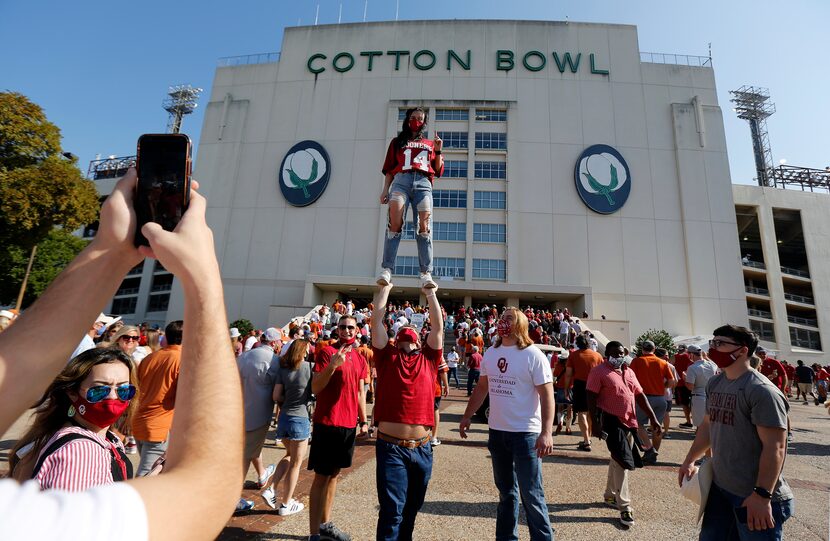 Emily Bingger of Norman has her photo taken in front of the Cotton Bowl before the Red River...