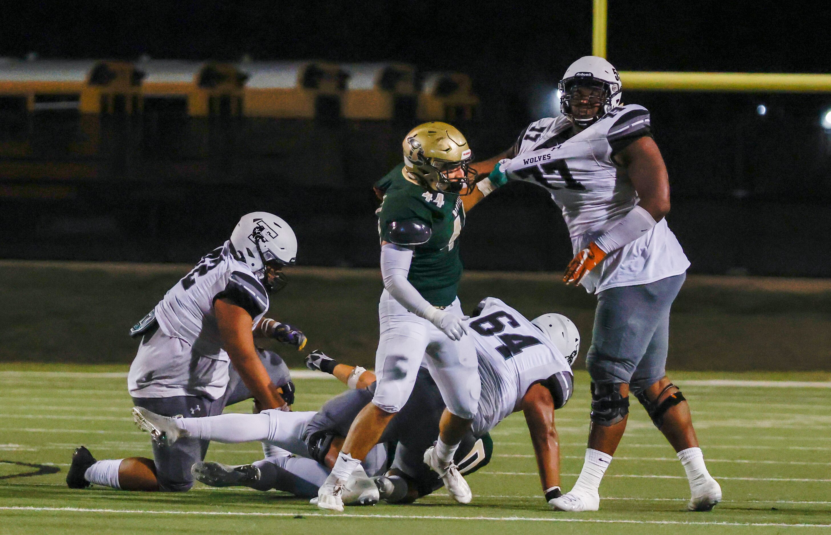 Birdville line backer Bynum Martinez grabs Mansfield Timberview offensive line Andre Cojoe...