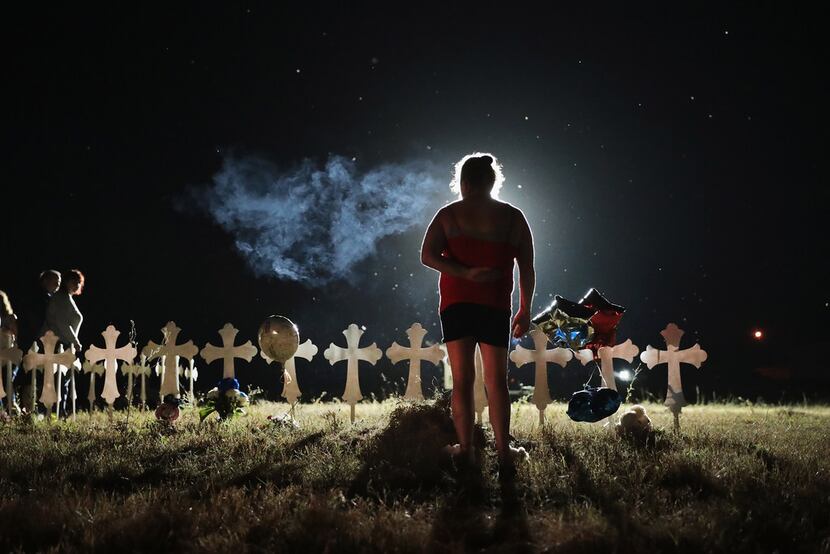 Twenty-six crosses stand in a field on the edge of town to honor the 26 victims killed at...