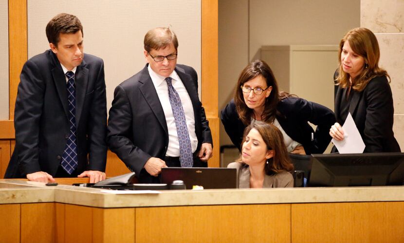 From left: Defense attorneys Cody Skipper and Toby Shook review testimony with prosecutors...