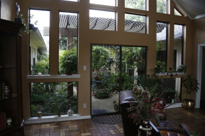 When hail splintered the original plastic frames of the living room windows, Sterry sawed,...