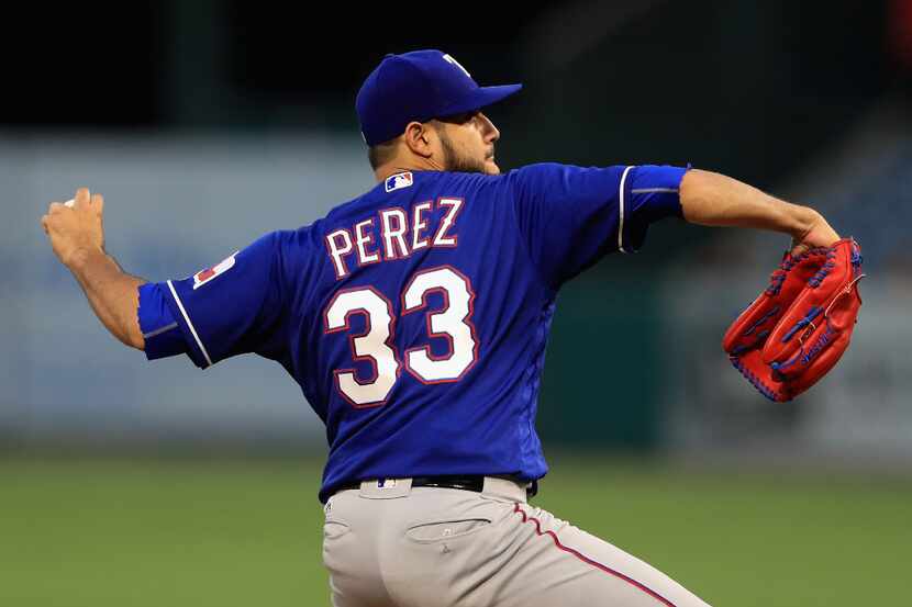 ANAHEIM, CA - AUGUST 24:  Martin Perez #33 of the Texas Rangers pitches during the first...
