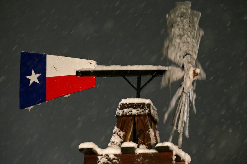 A windmill with snow Thursday Dec. 7, 2017 in Leon Springs, Texas. ORG XMIT:...