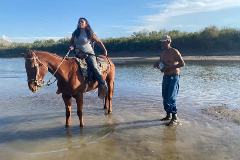 Beronica Ureste rides her horse to the middle of the Rio Grande on Tuesday, Nov. 2, to...