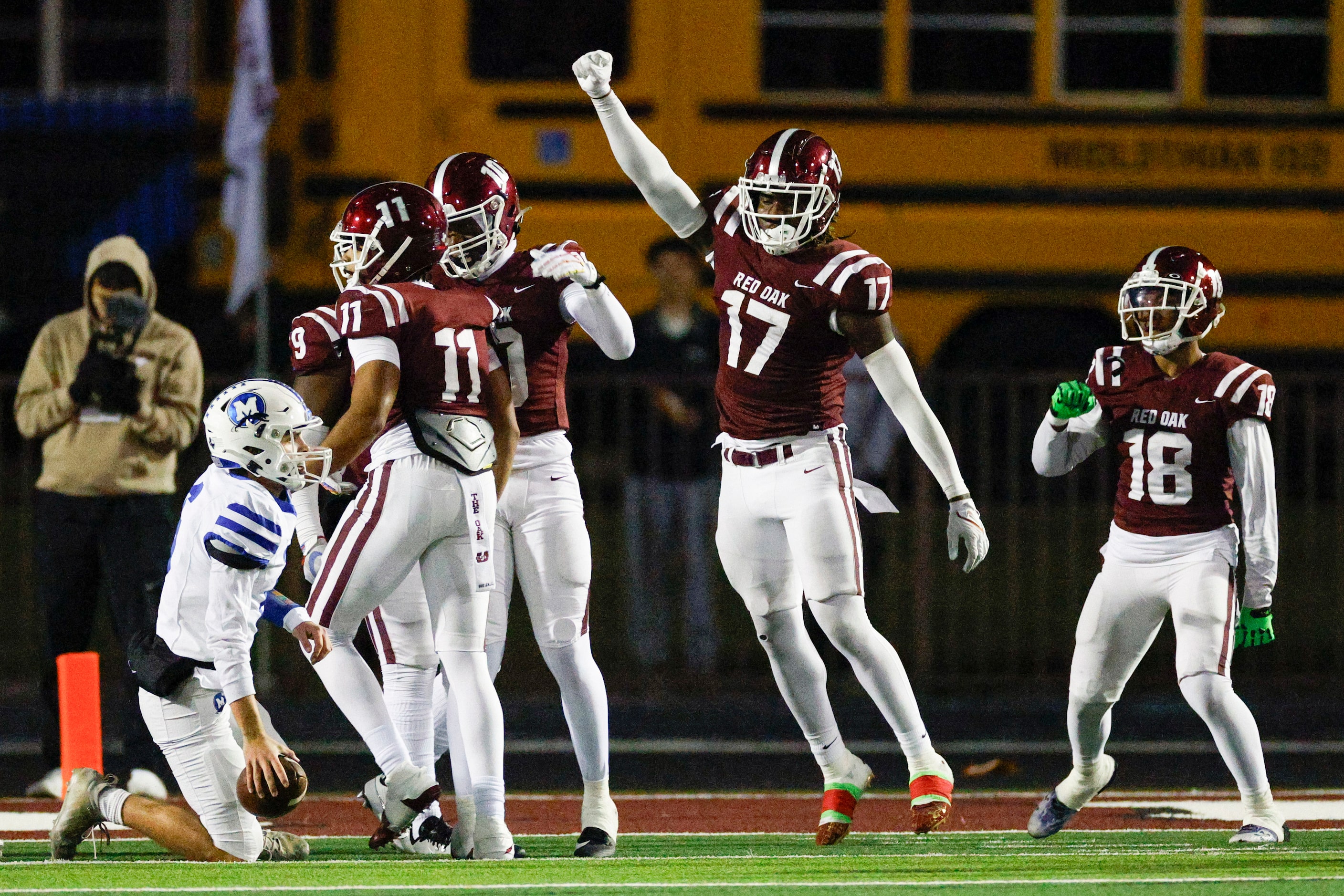 Red Oak defensive lineman Jordan Omolola (17) celebrates after stopping Midlothian to force...