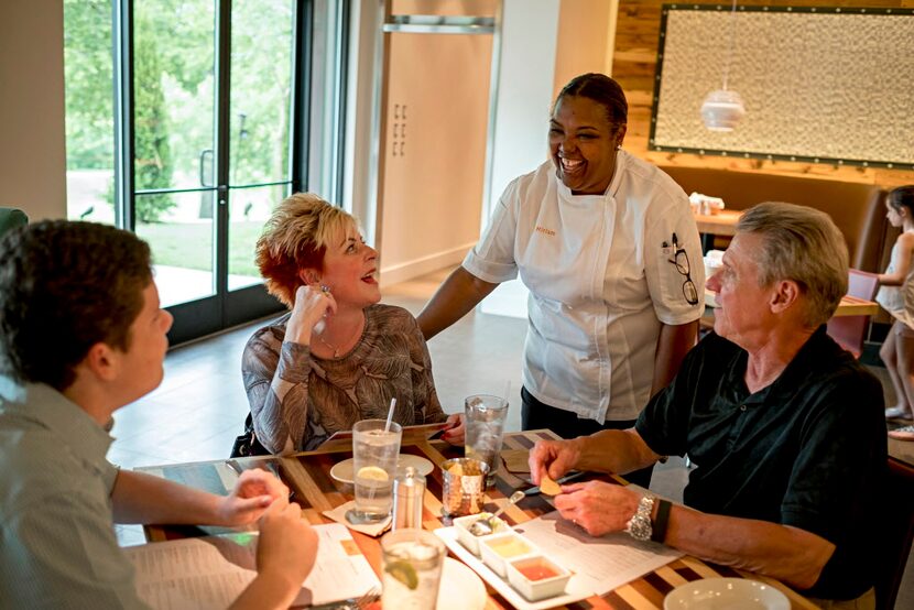  Mesero general manager Miriam Jimenez (standing) laughs as she talks with customers Jake...