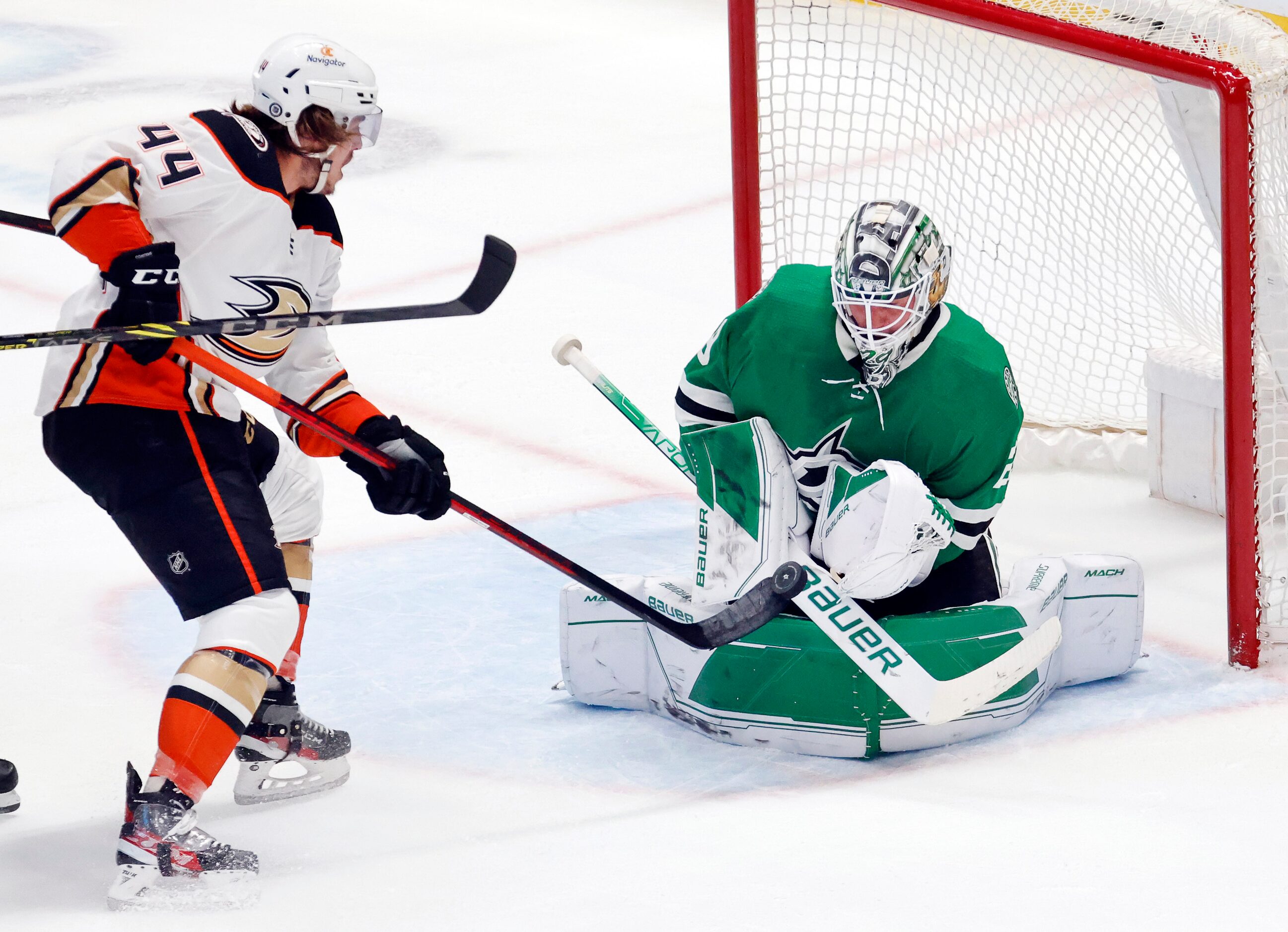 Dallas Stars goaltender Jake Oettinger (29) stops a shot by Anaheim Ducks left wing Max...