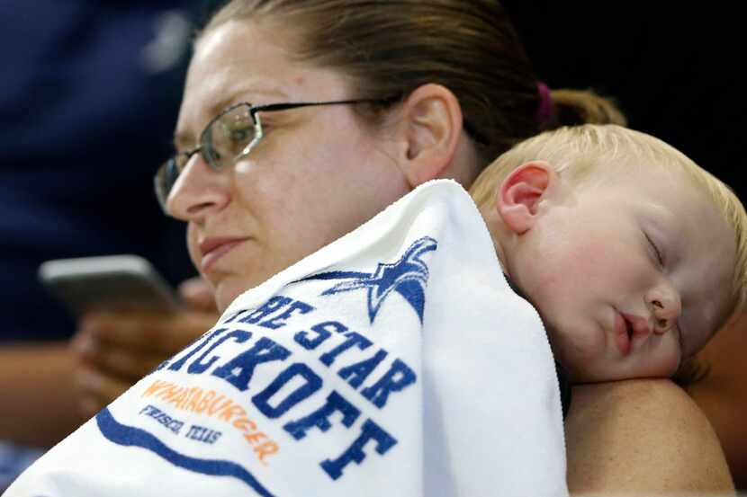 18-month-old Steven Ritchie is sound asleep as he is held by his mother, Christie Ritchie of...