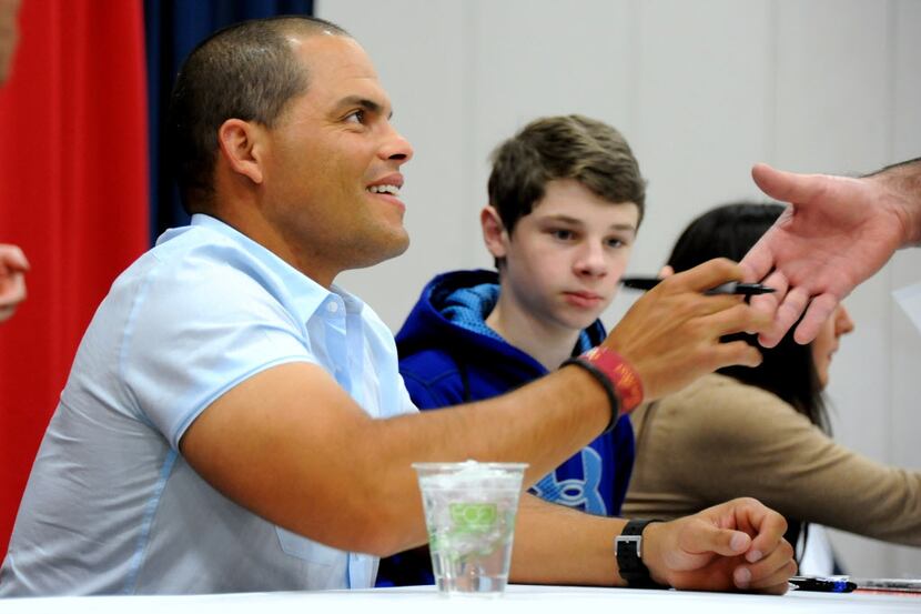 'Pudge' Ivan Rodriguez shakes hands with a Rangers fan at Ticketstock at the Dallas...