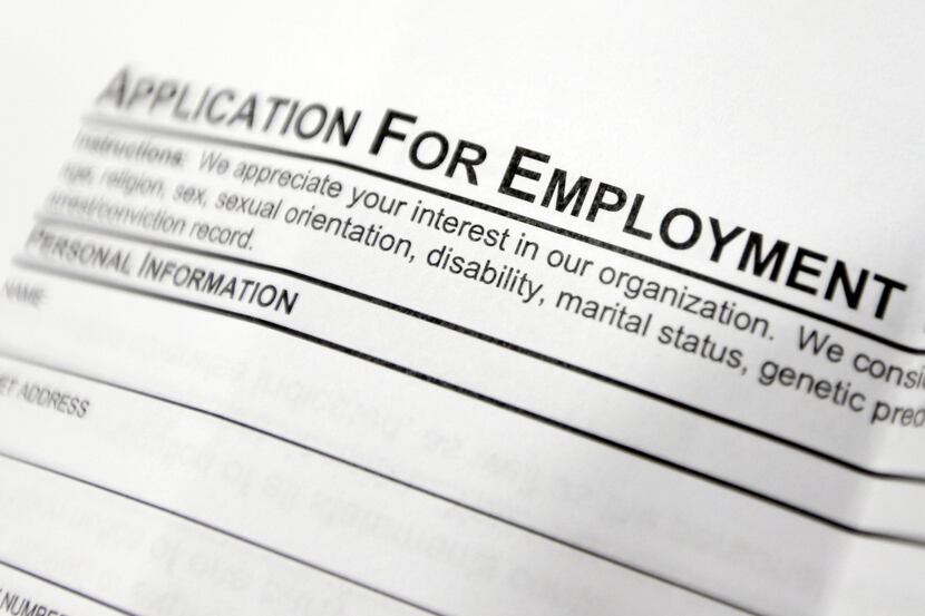 FILE - This April 22, 2014, file photo shows an employment application form on a table...