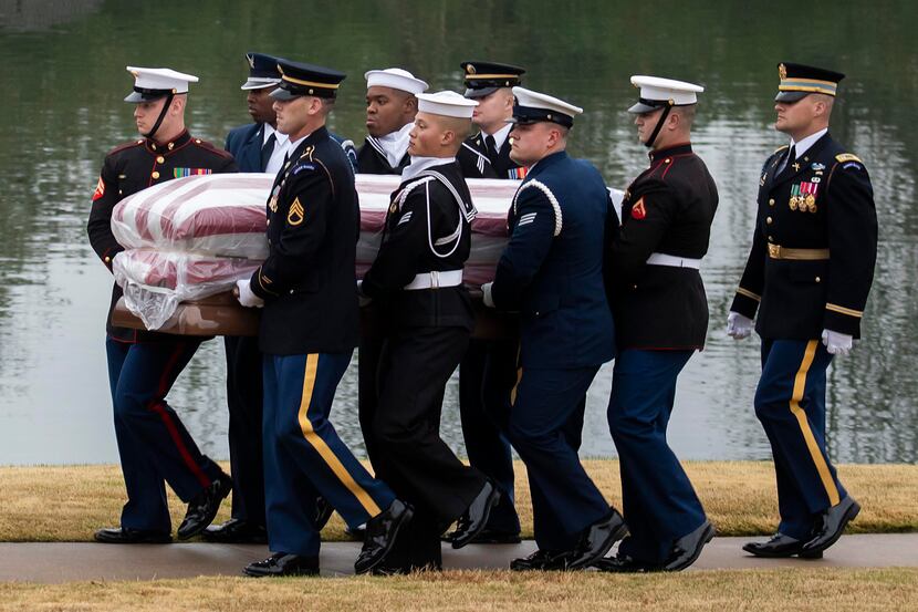 The flag-draped casket of President George H.W. Bush is carried to a burial plot close to...