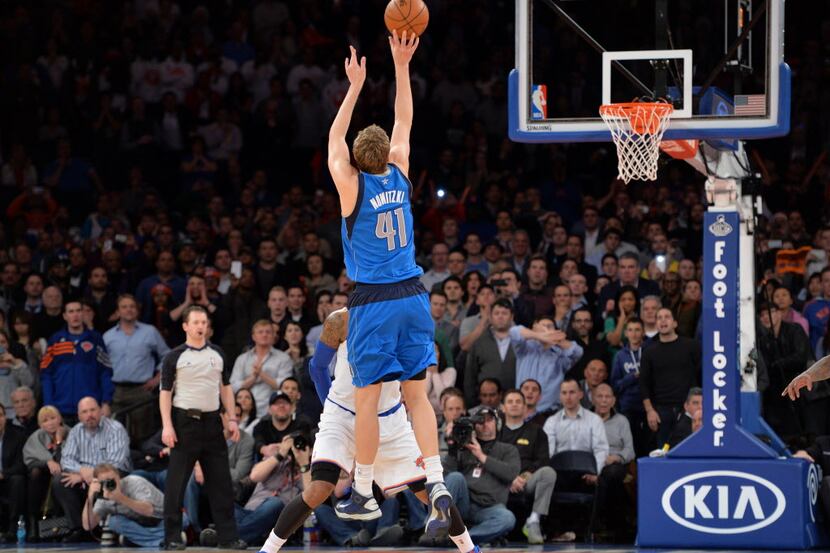 Dirk Nowitzki of the Dallas Mavericks shoots the winning shot over Carmelo Anthony of the...