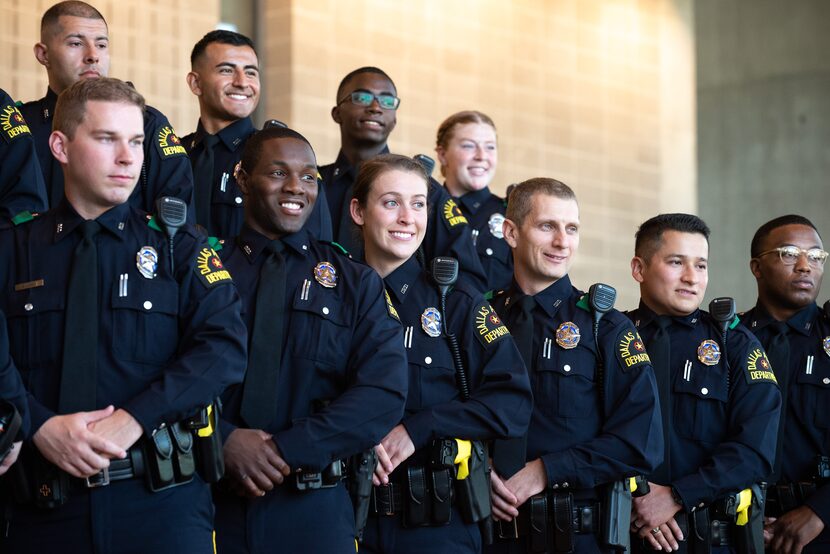 Police officers including Erick Brown, front row, second from left, Alyssa Hoppensteadt,...