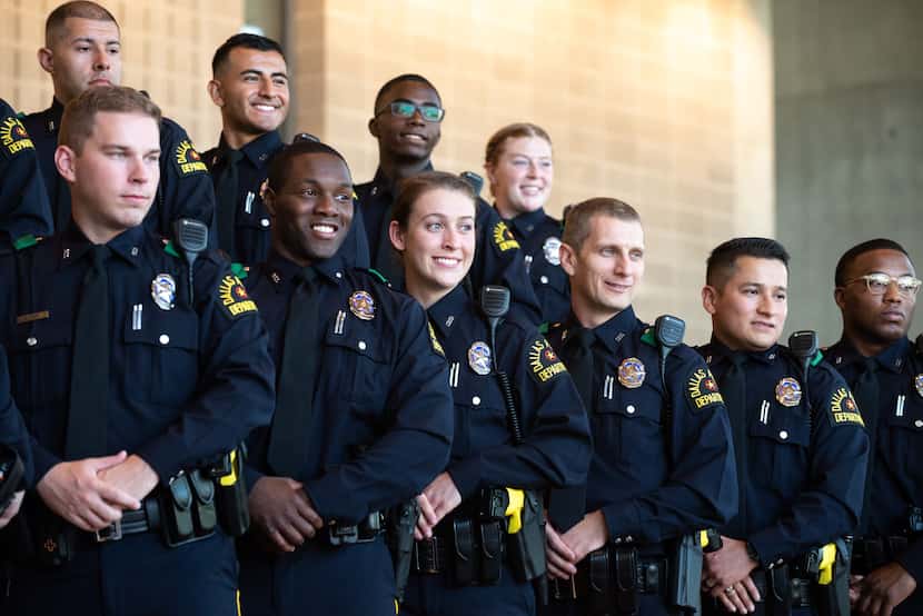 Police officers including Erick Brown, front row, second from left, Alyssa Hoppensteadt,...