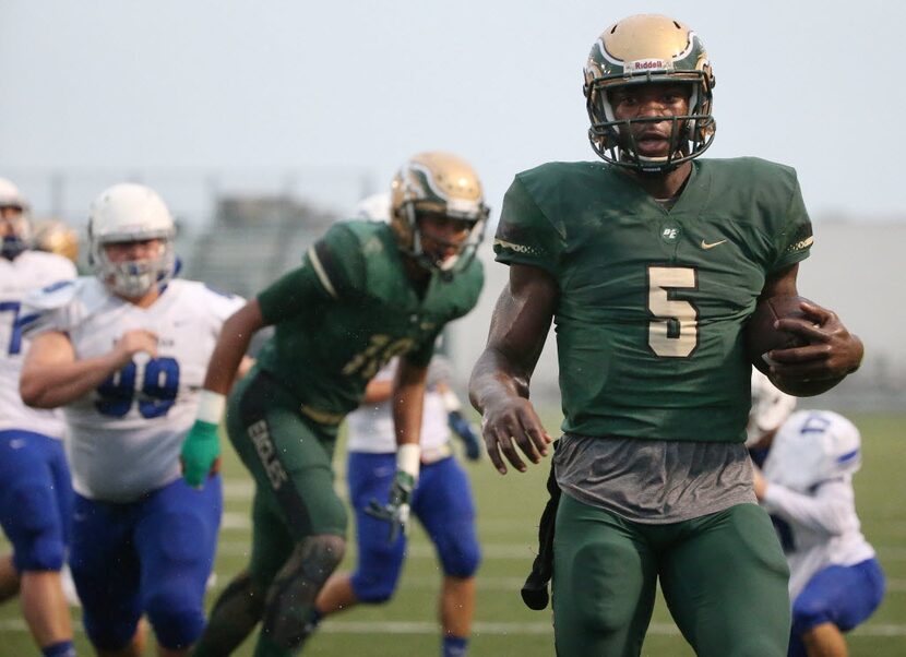 DeSoto quarterback Trsiten Wallace rushes for a touchdown in the first quarter to make the...