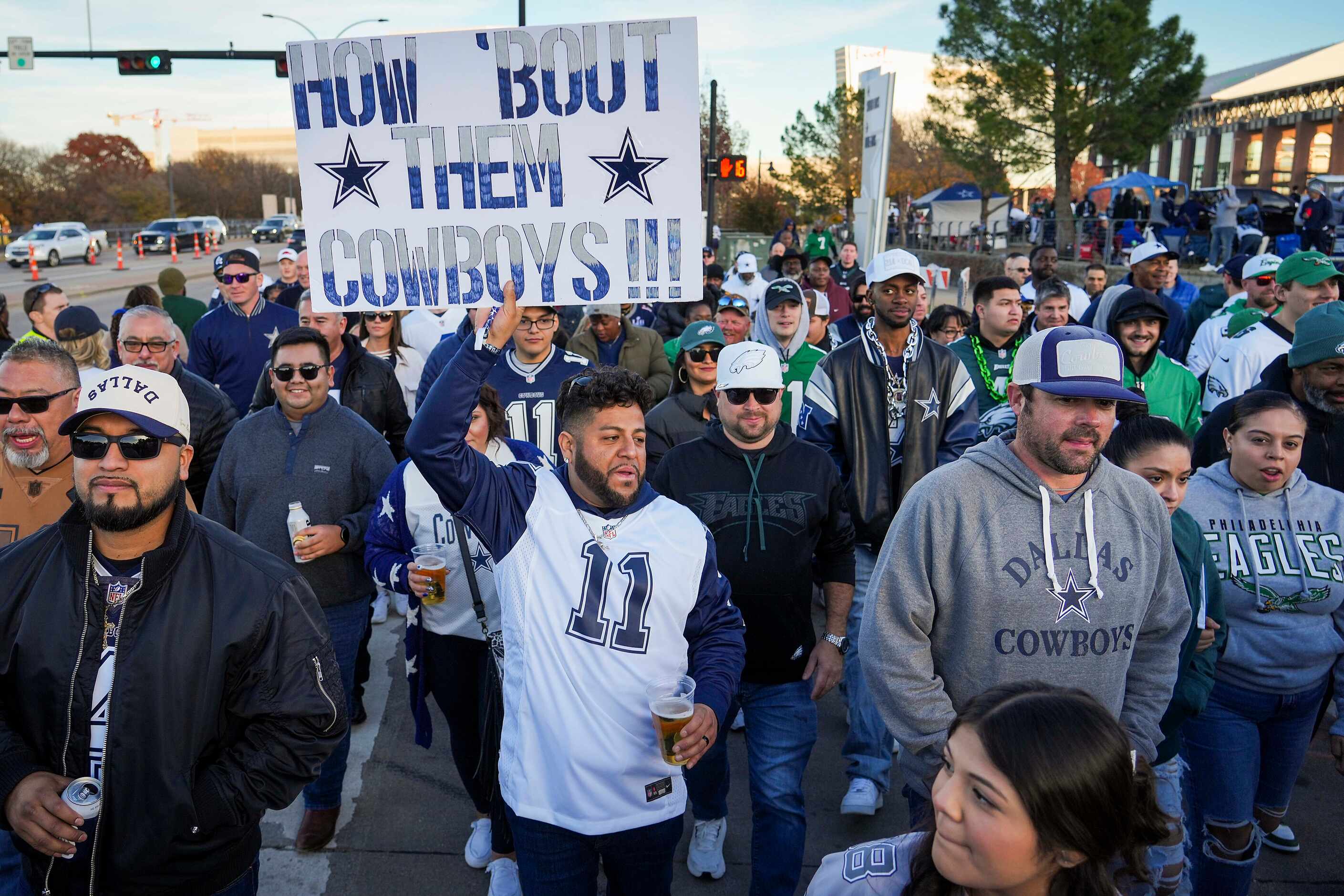 Dallas Cowboys fan Ray Hernandez  cheers as fans head to the stadium before an NFL football...