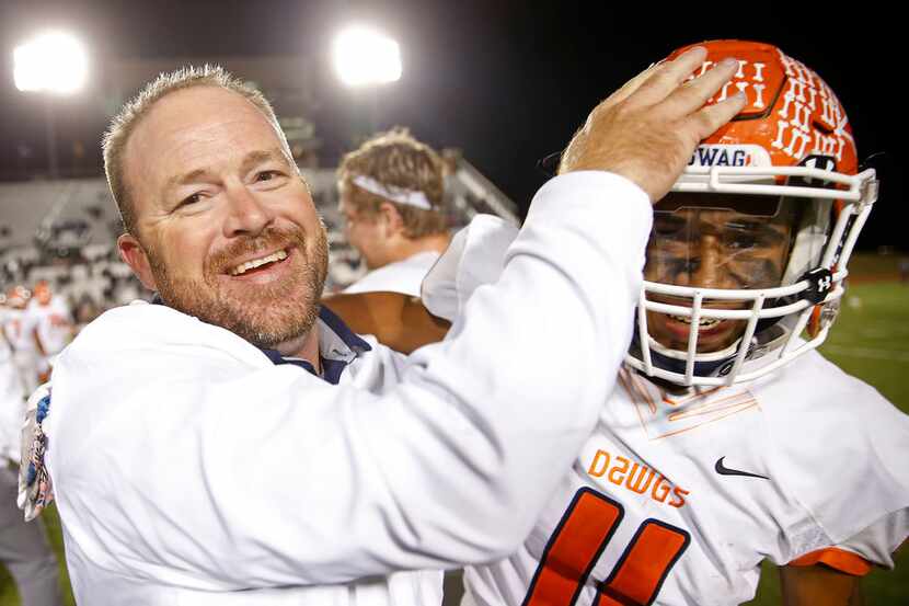 McKinney North coach Mike Fecci (left) celebrates a 59-40 win over Little Elm with Toby...