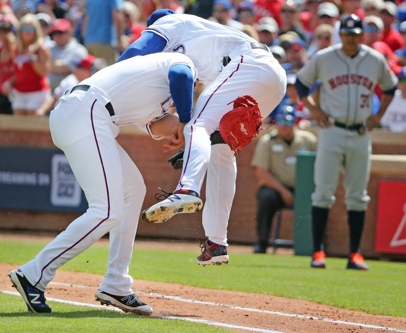 Texas Rangers first baseman Joey Gallo (13) collides with  pitcher Cole Hamels (35) on...