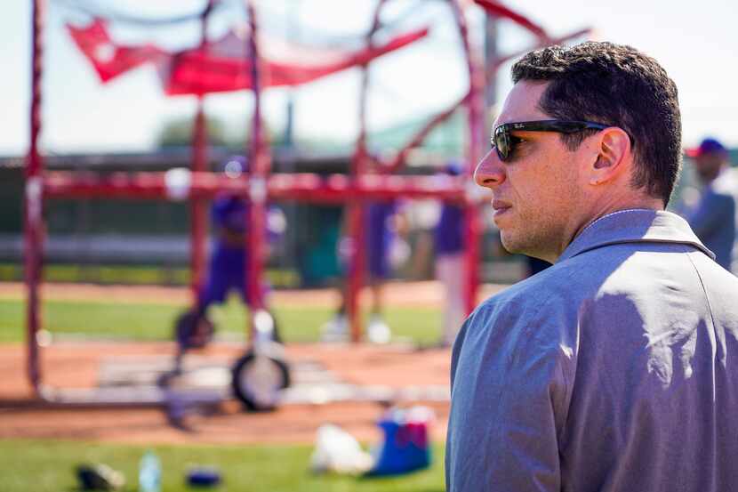 Texas Rangers general manager Jon Daniels looks on during a spring training workout at the...