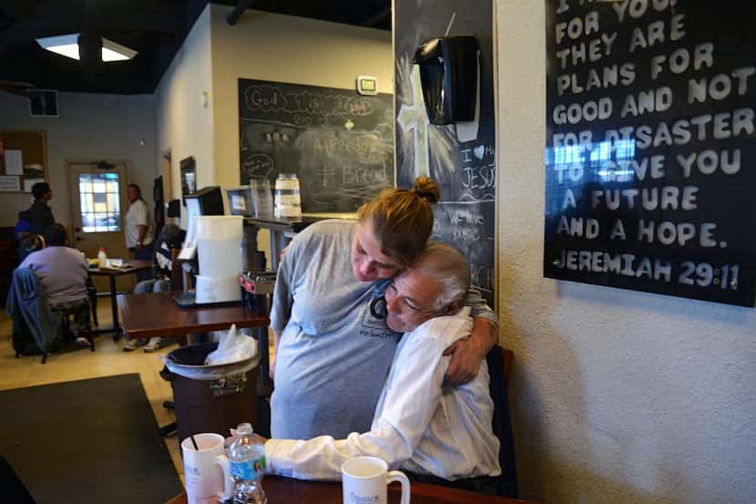 
Volunteer Patricia Gosnell hugs Pedro Martinez, who is currently homeless, during lunch at...