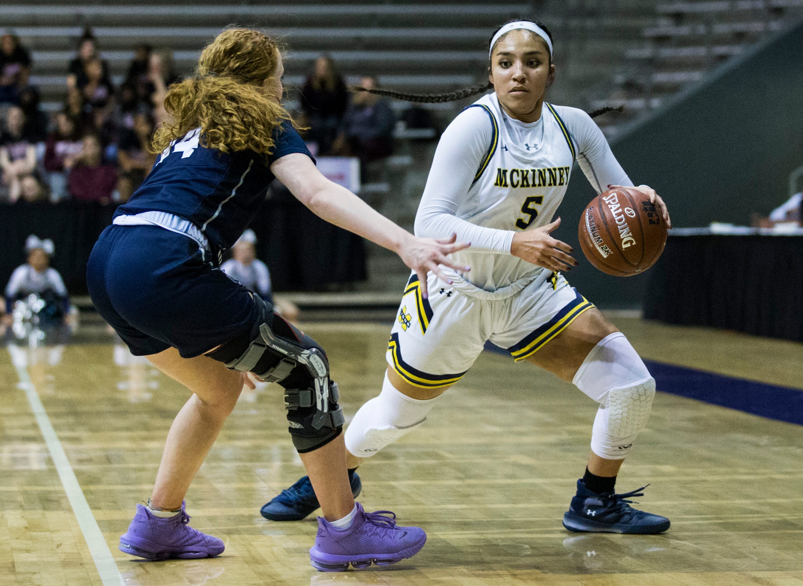 McKinney guard Trinity White (5) gets around Pflugerville Hendrickson guard Sarah Malinowski...