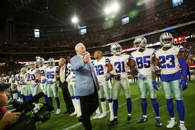 Dallas Cowboys owner Jerry Jones ushered photographers back to their position as stadium...