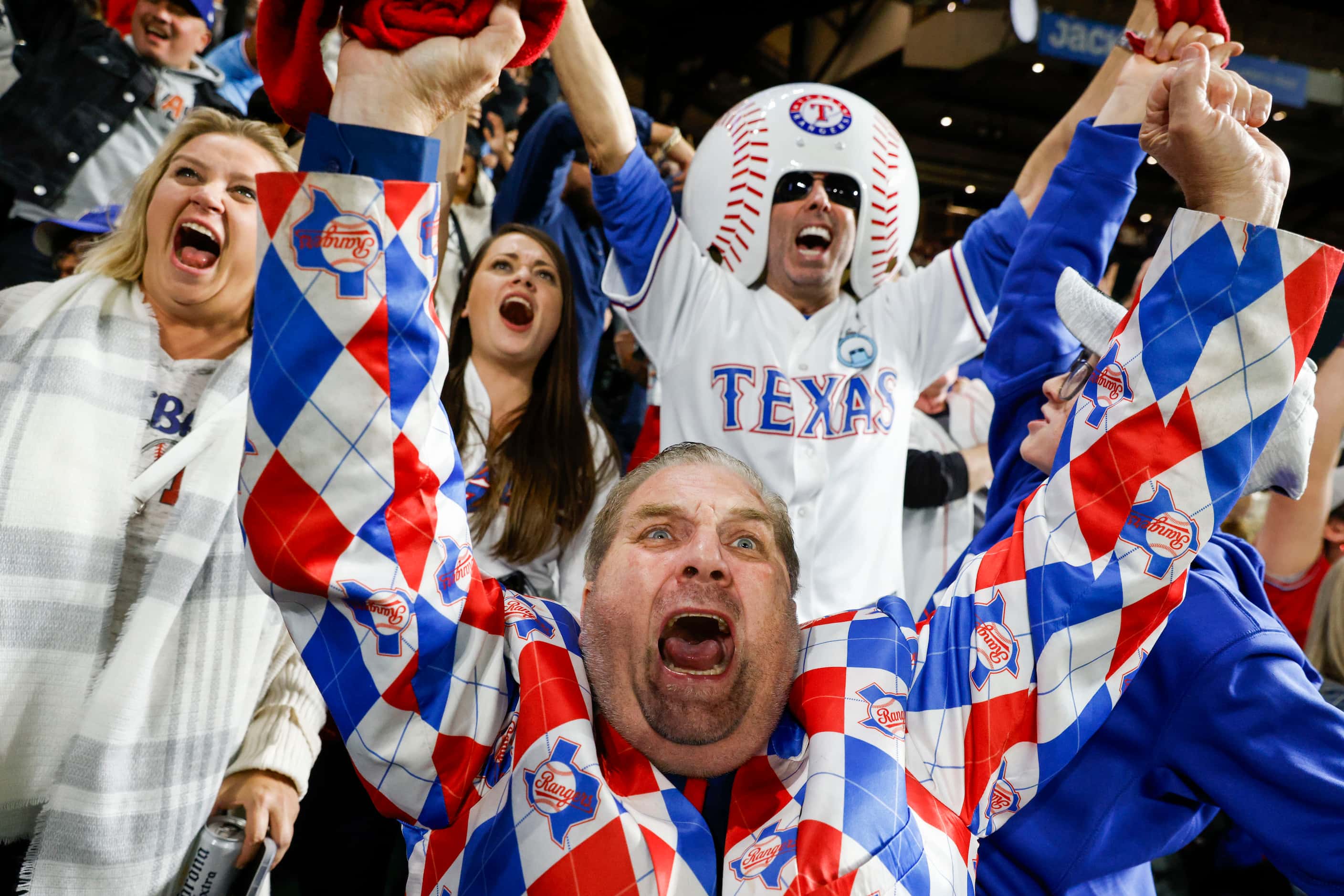 Texas Rangers fan from 1972, Terry Cox, (center) from Tyler, TX, including other, cheer...