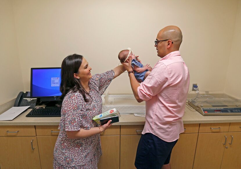 Pediatrician Jacqueline Nortman and DISD trustee Miguel Solis with their daughter, Olivia,...