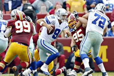Dallas Cowboys quarterback Tony Romo (9) scrambles out of the pocket during the second half...
