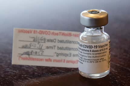 A vial that contained five doses of the Pfizer COVID-19 vaccination is on a table after a...