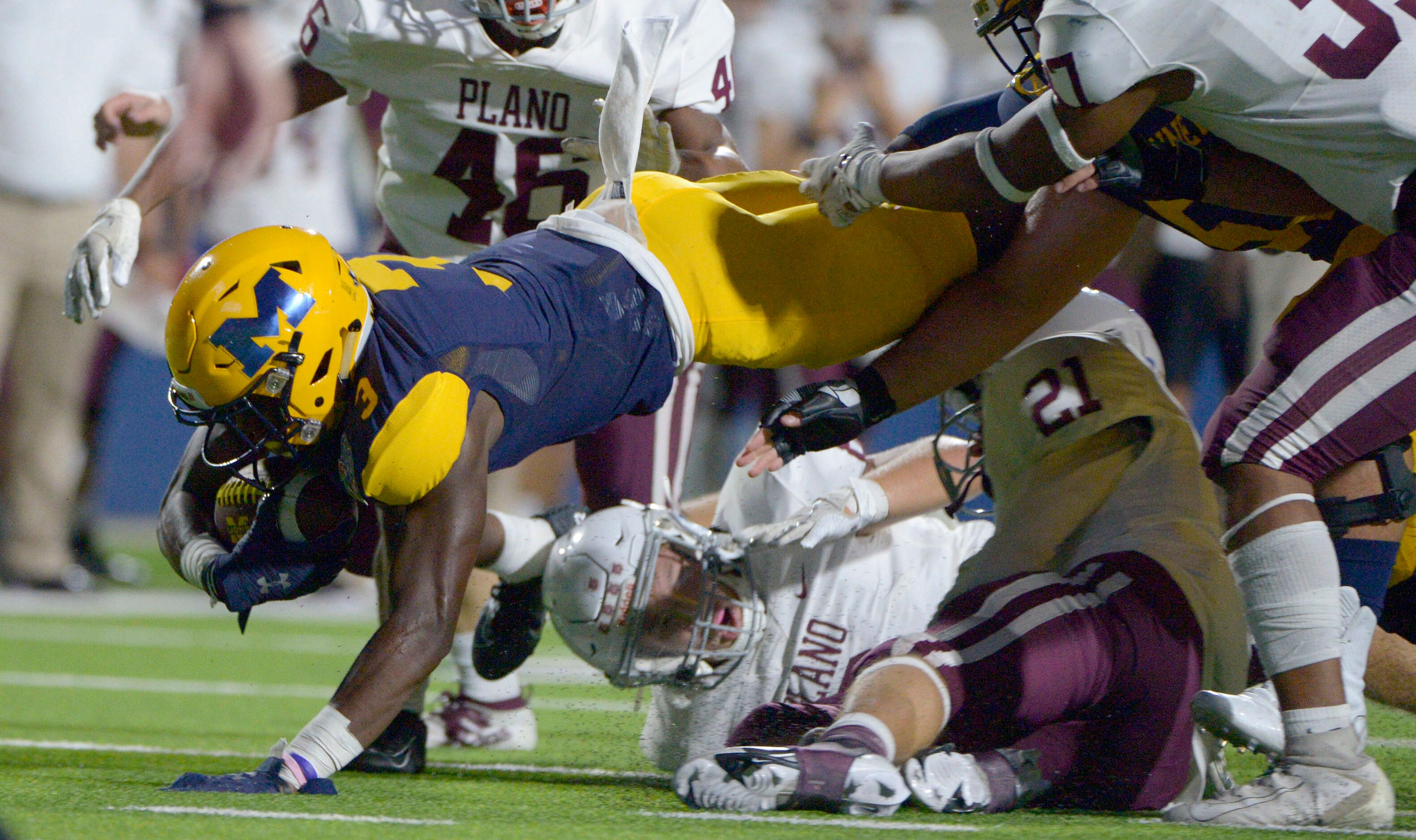 McKinneyÕs Omari Walker reaches for extra yards in the second quarter during a high school...