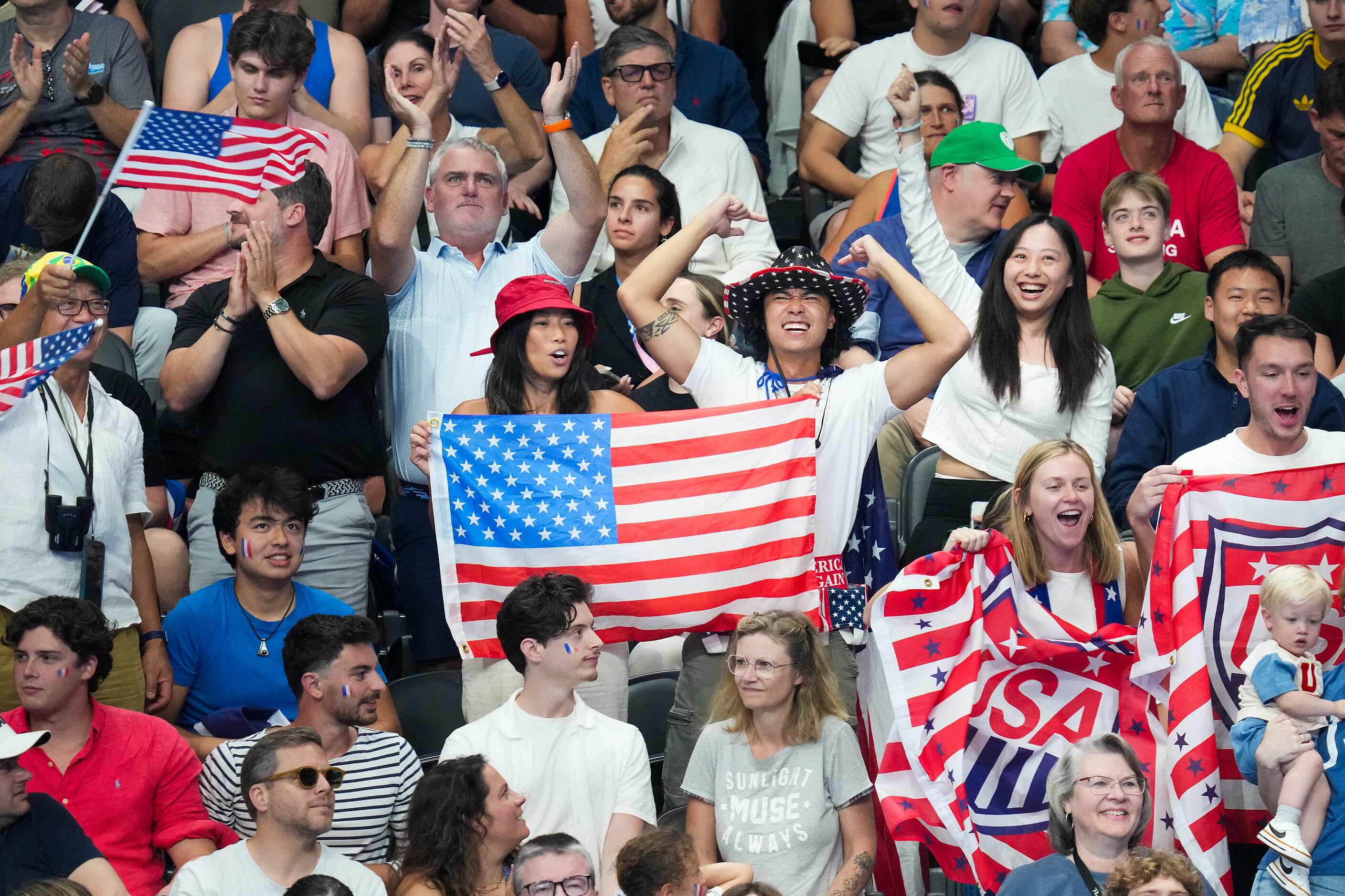 Fans cheer for the Carson Foster of the United State before the men’s 400-meter individual...