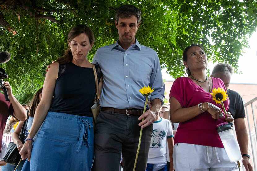 Democratic presidential candidate Beto O'Rourke walks next to his wife, Amy, and US Rep....