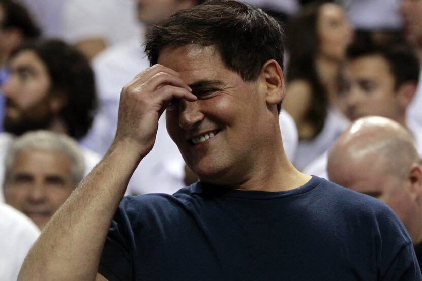 Dallas Mavericks woner Mark Cuban smiles during the fourth quarter during Game 2 of the NBA...