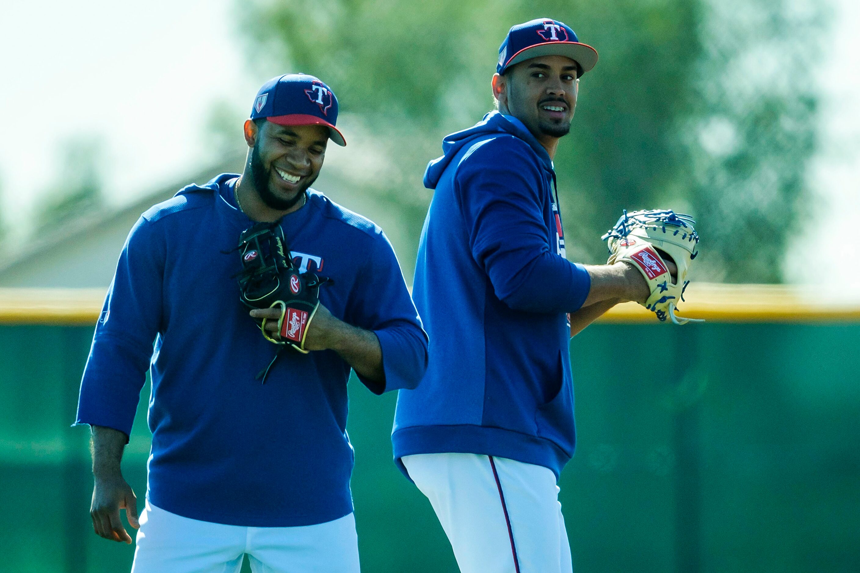 Texas Rangers shortstop Elvis Andrus (left) laughs with first baseman Ronald Guzman during a...