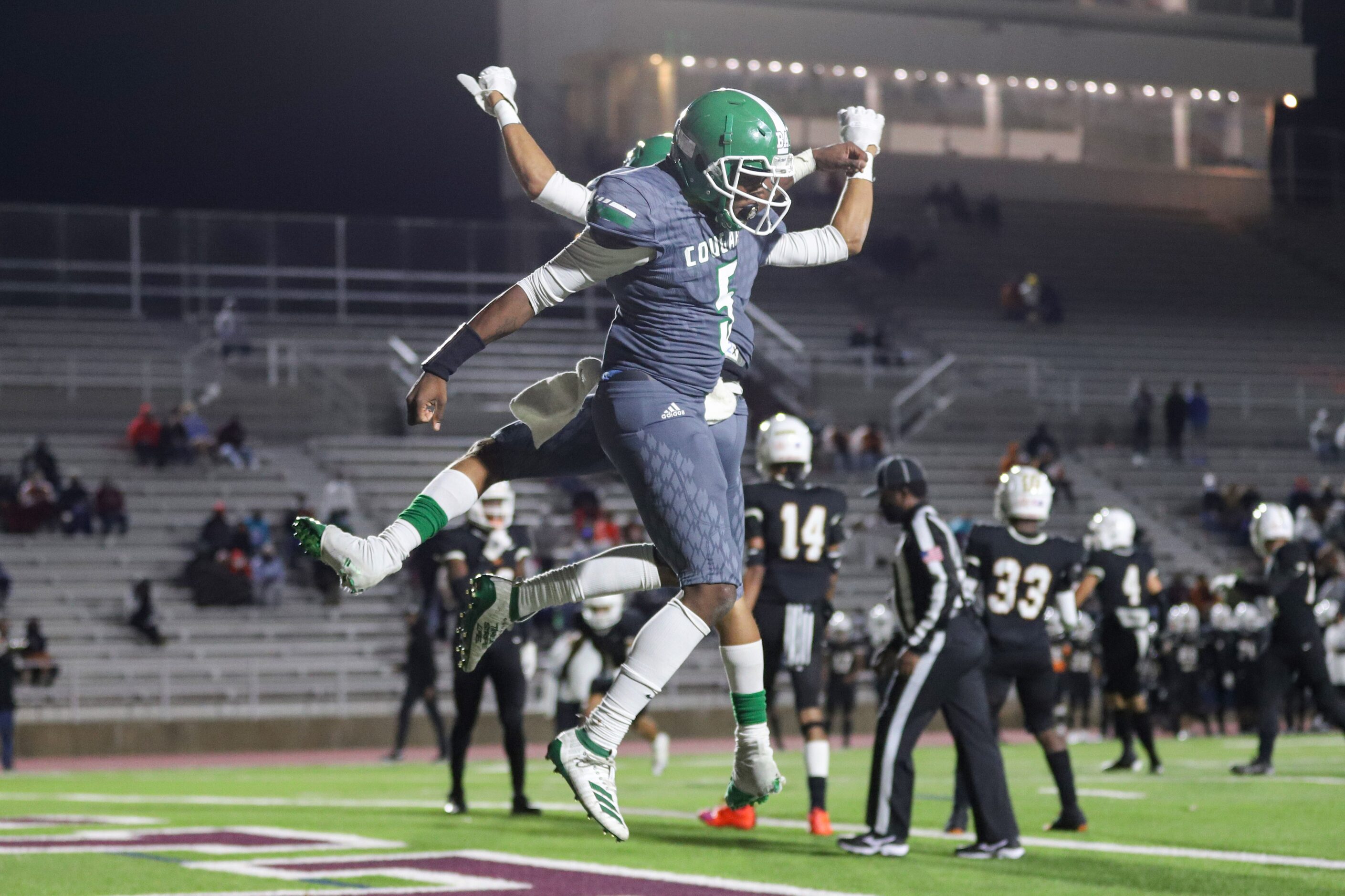 Bryan Adams running back Antoine Murphy (5) celebrates a touchdown with quarterback Jordan...