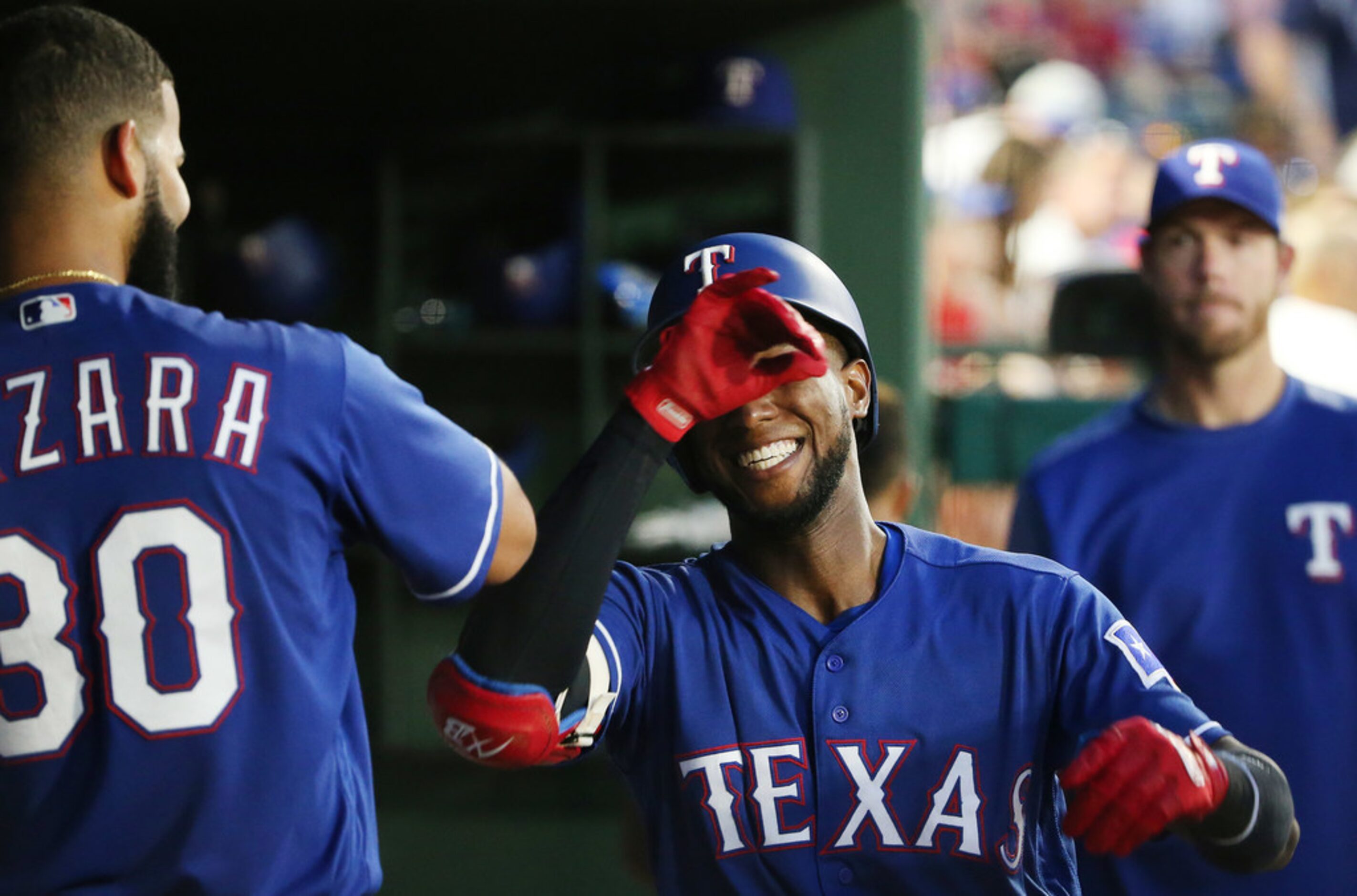 Texas Rangers shortstop Jurickson Profar (19) celebrates after hitting a home run to make...