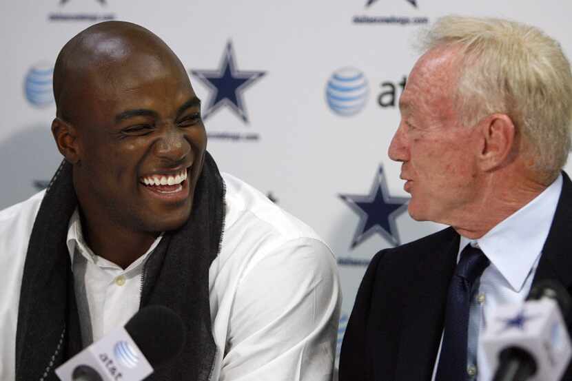 Dallas Cowboys linebacker DeMarcus Ware (left) laughs with owner Jerry Jones after signing a...