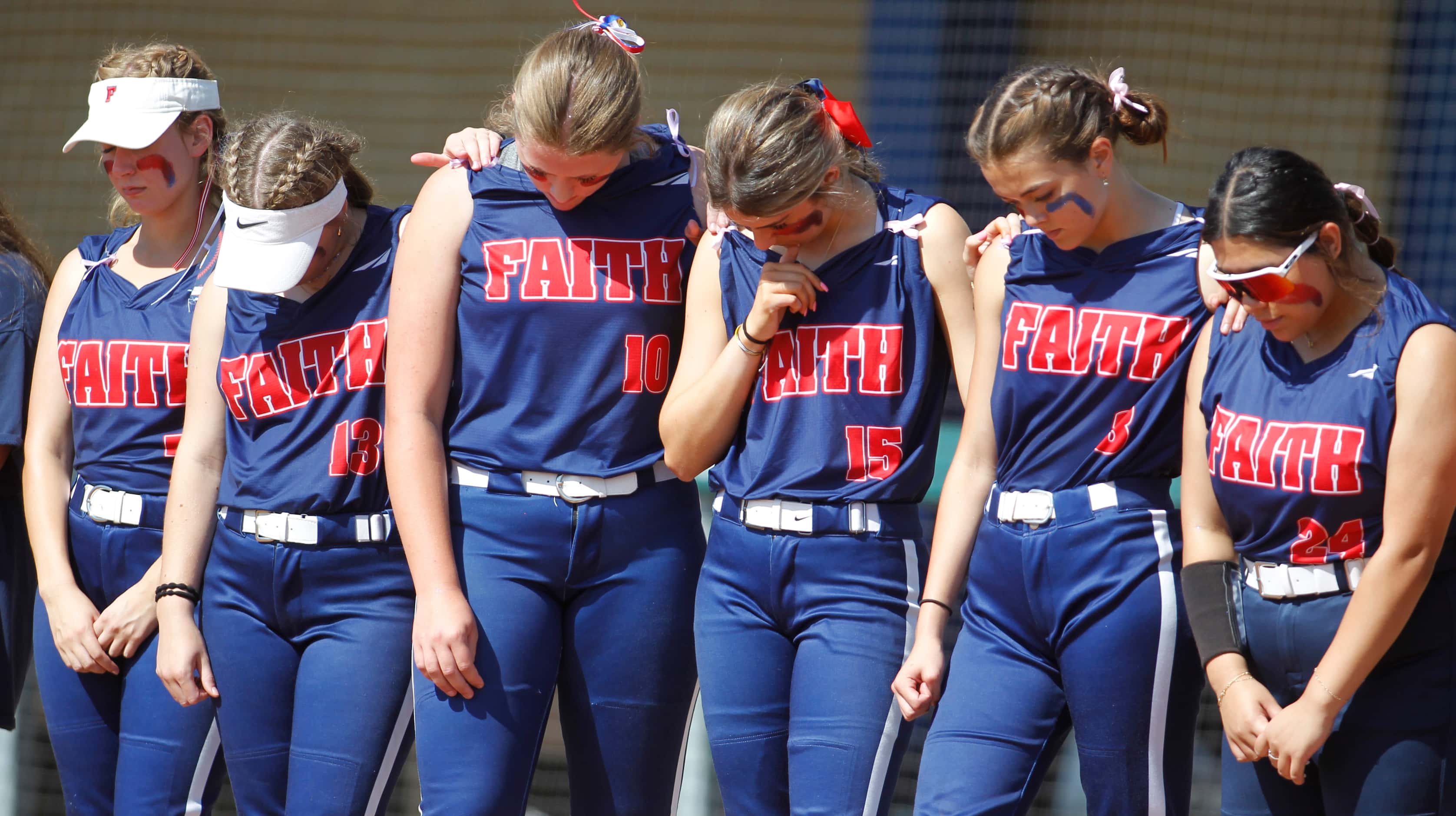 Grapevine Faith Christian players pause for a prayer before the start of their game against...