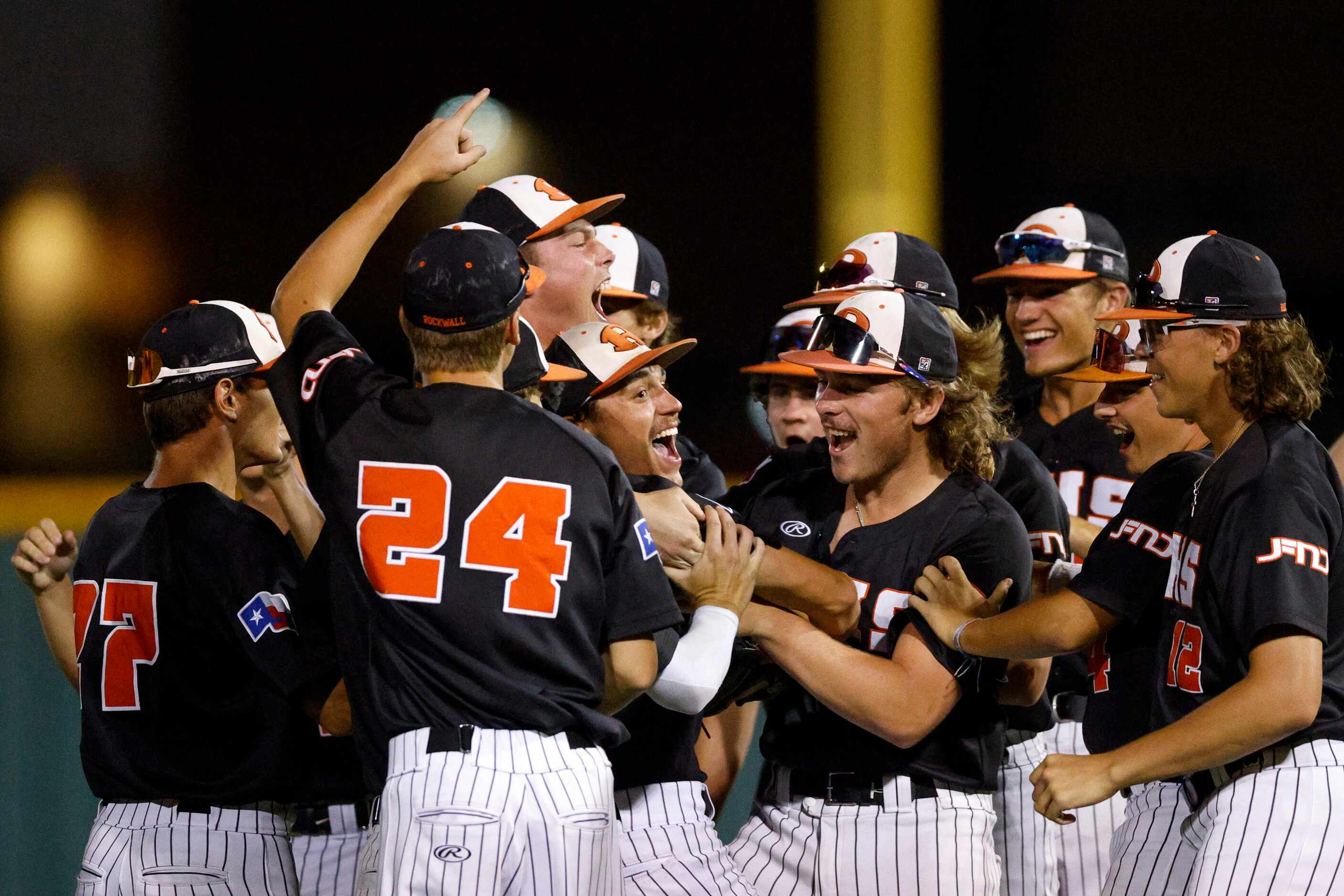 Rockwall catcher Jake Overstreet (11) celebrates with pitcher Mac Rose (6) after winning a...