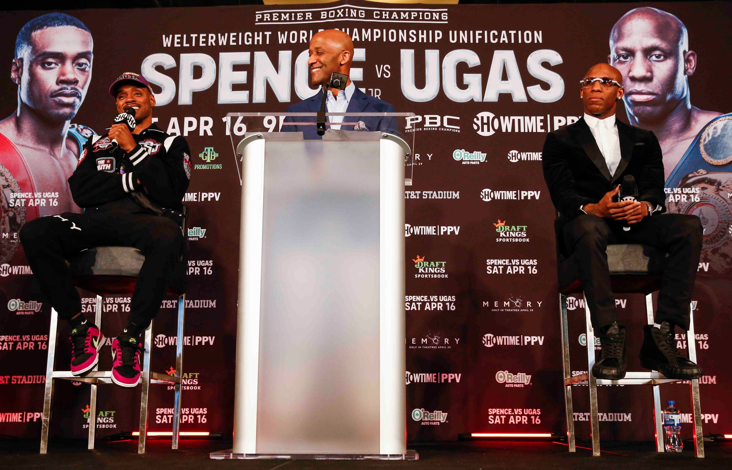 Errol Spence Jr., left, as Yordenis Ugas listens during a press conference ahead of their...