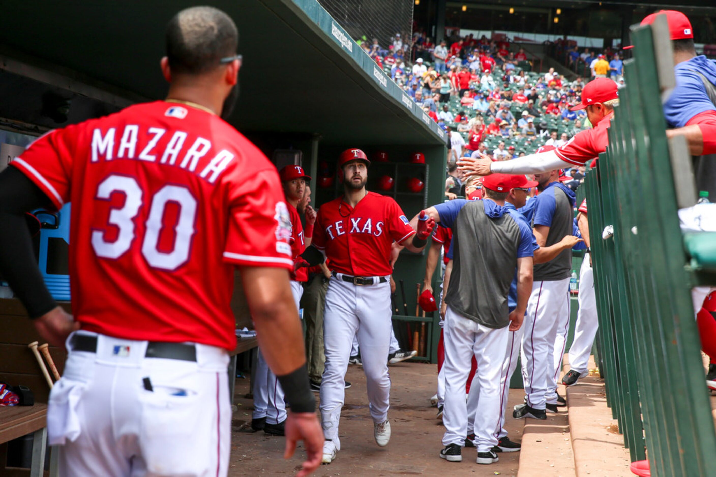 Texas Rangers left fielder Joey Gallo (13) is congratulated by his team after hitting his...