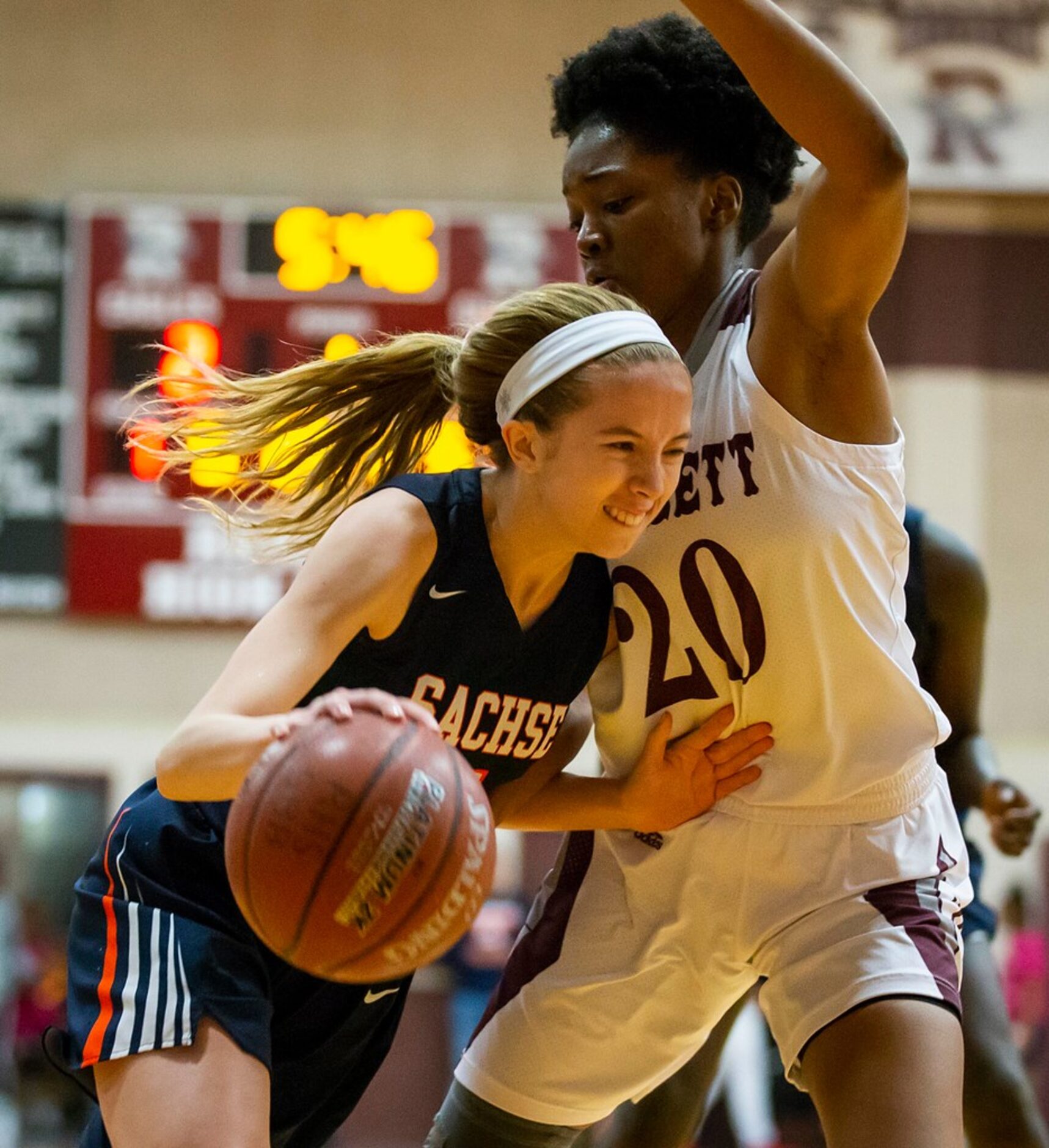 Sachse guard Avery Crouse (5) drives on Rowlett forward Ngozi Obineke (20) during a District...