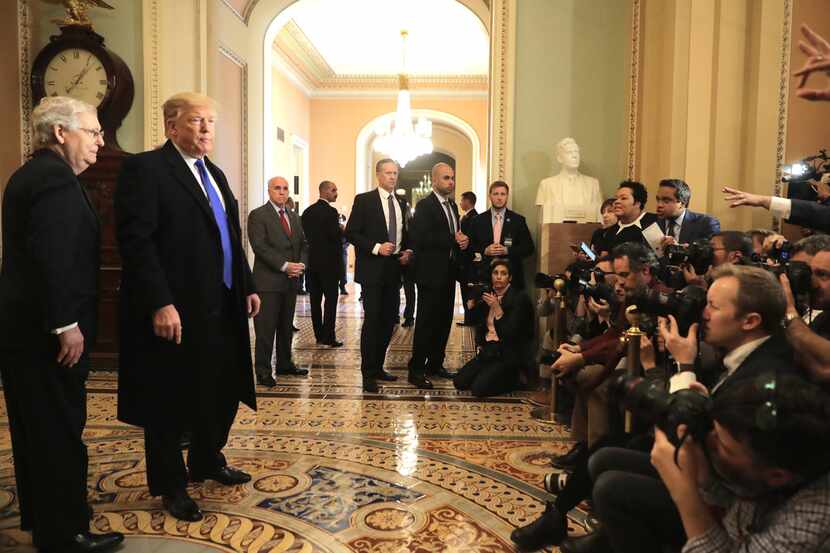  President Donald Trump speaks to reporters as U.S. Senate Majority Leader Sen. Mitch...